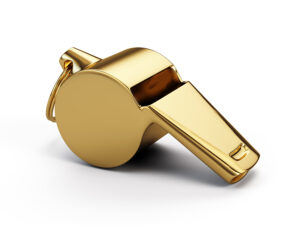 Gold whistle isolated on white